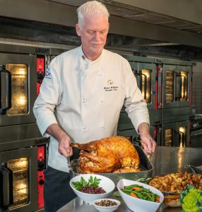 Rosen Hotels & Resorts Thanksgiving Buffets Chef presents baked turkey